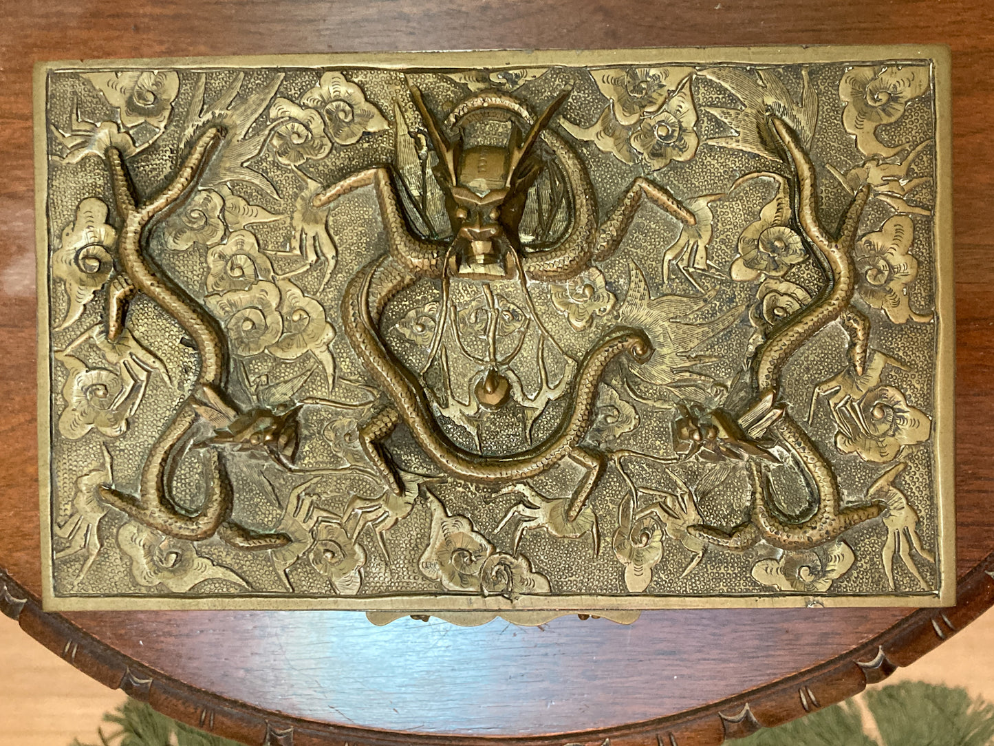Decorative brass box with intricate design on a wooden surface Antique Hand Engraved Sculptural Brass Dragon Wood Lined Cigar Box