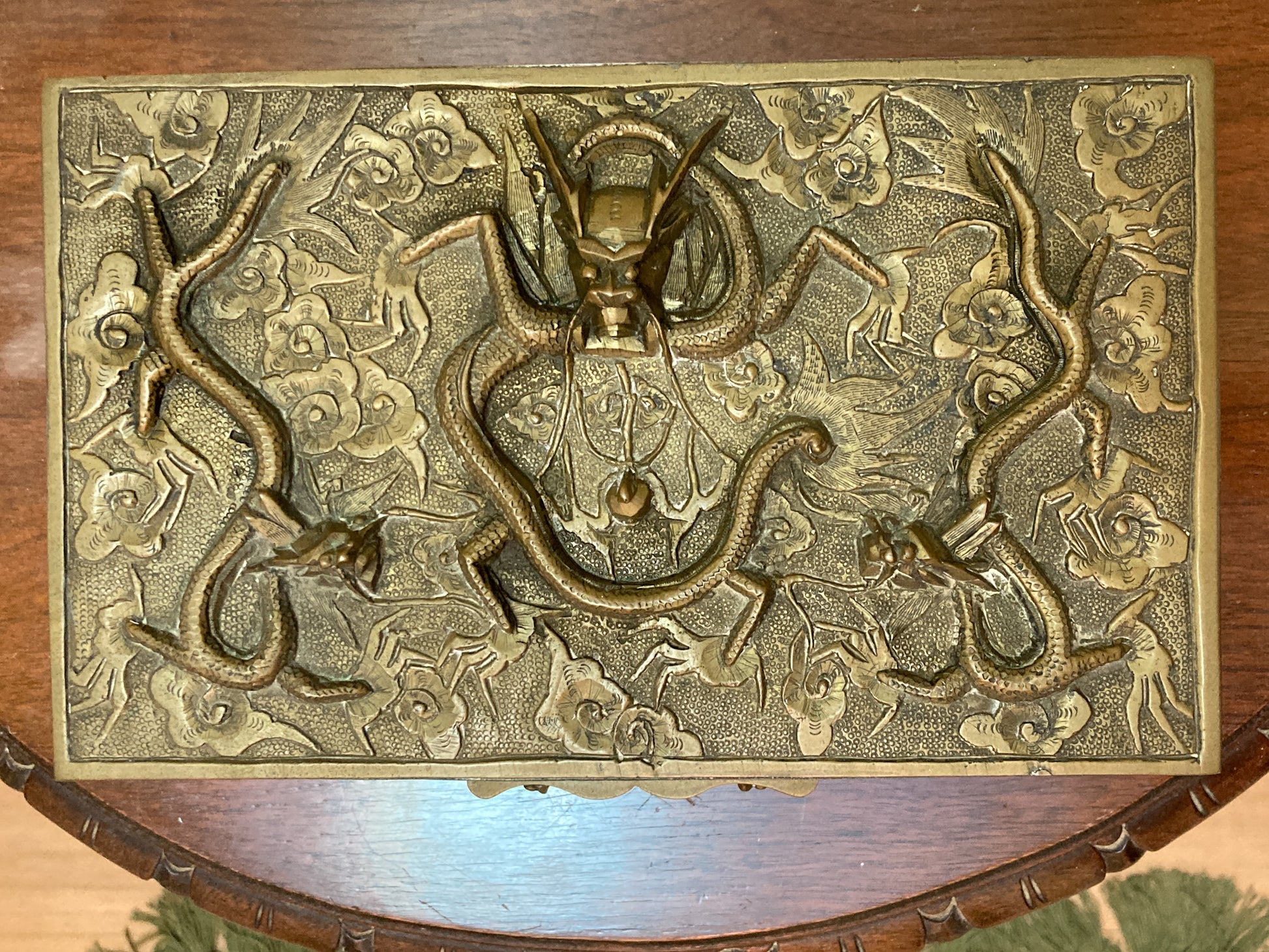 Decorative brass box with intricate design on a wooden surface Antique Hand Engraved Sculptural Brass Dragon Wood Lined Cigar Box