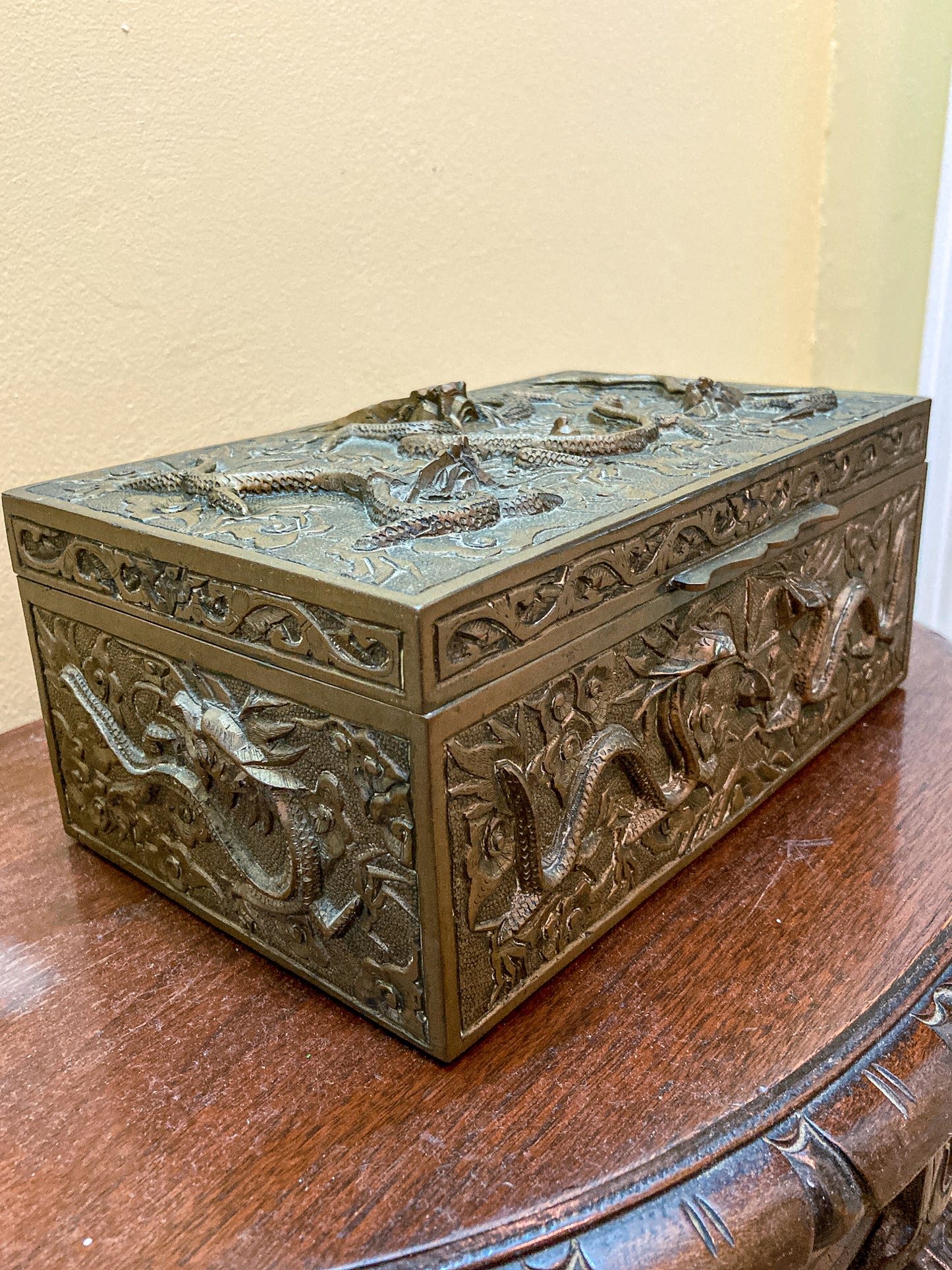 brass box with dragon carvings on a wooden surface Antique Hand Engraved Sculptural Brass Dragon Wood Lined Cigar Box