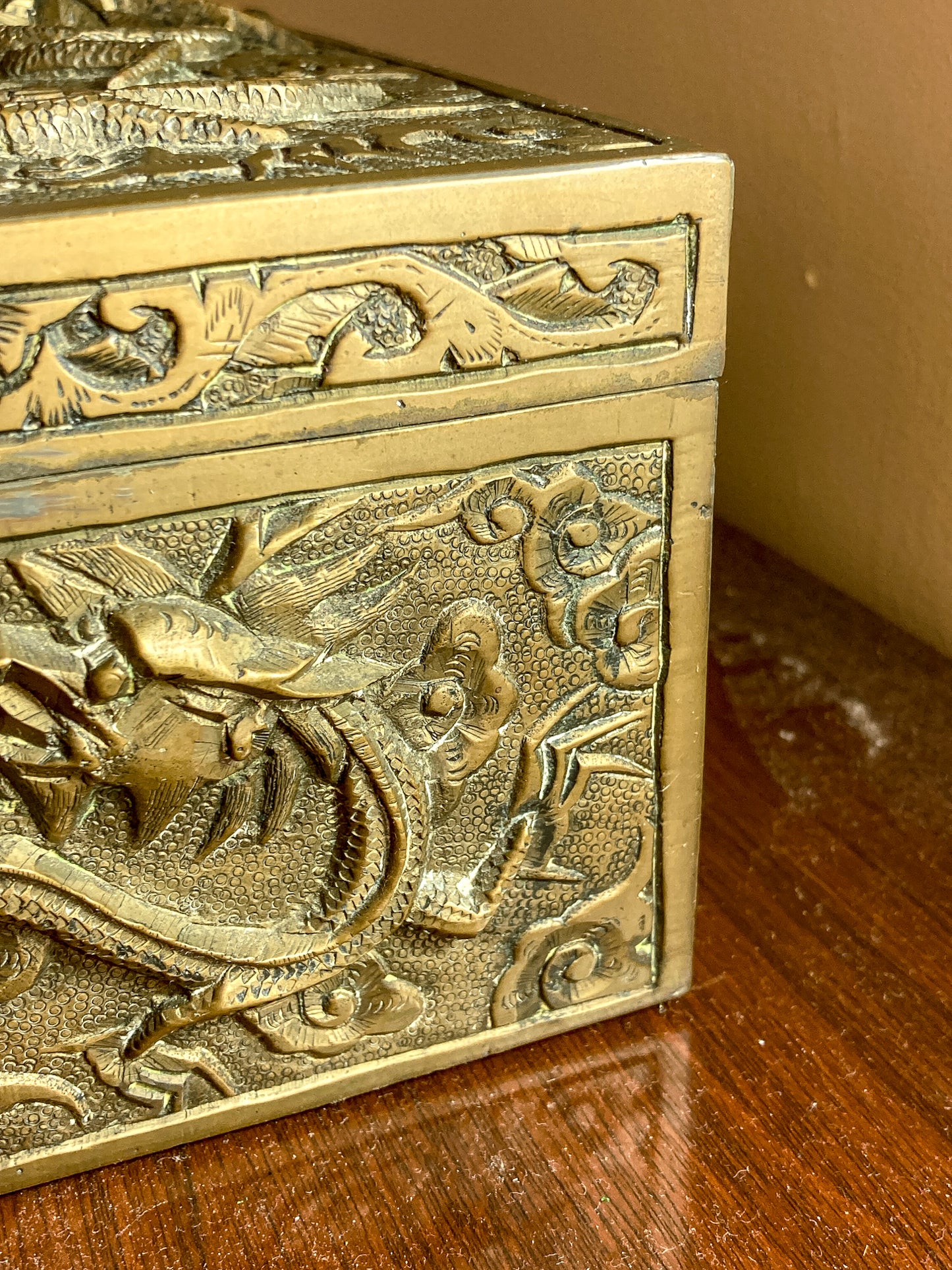 Decorative brass box with intricate carvings on a wooden surface Antique Hand Engraved Sculptural Brass Dragon Wood Lined Cigar Box