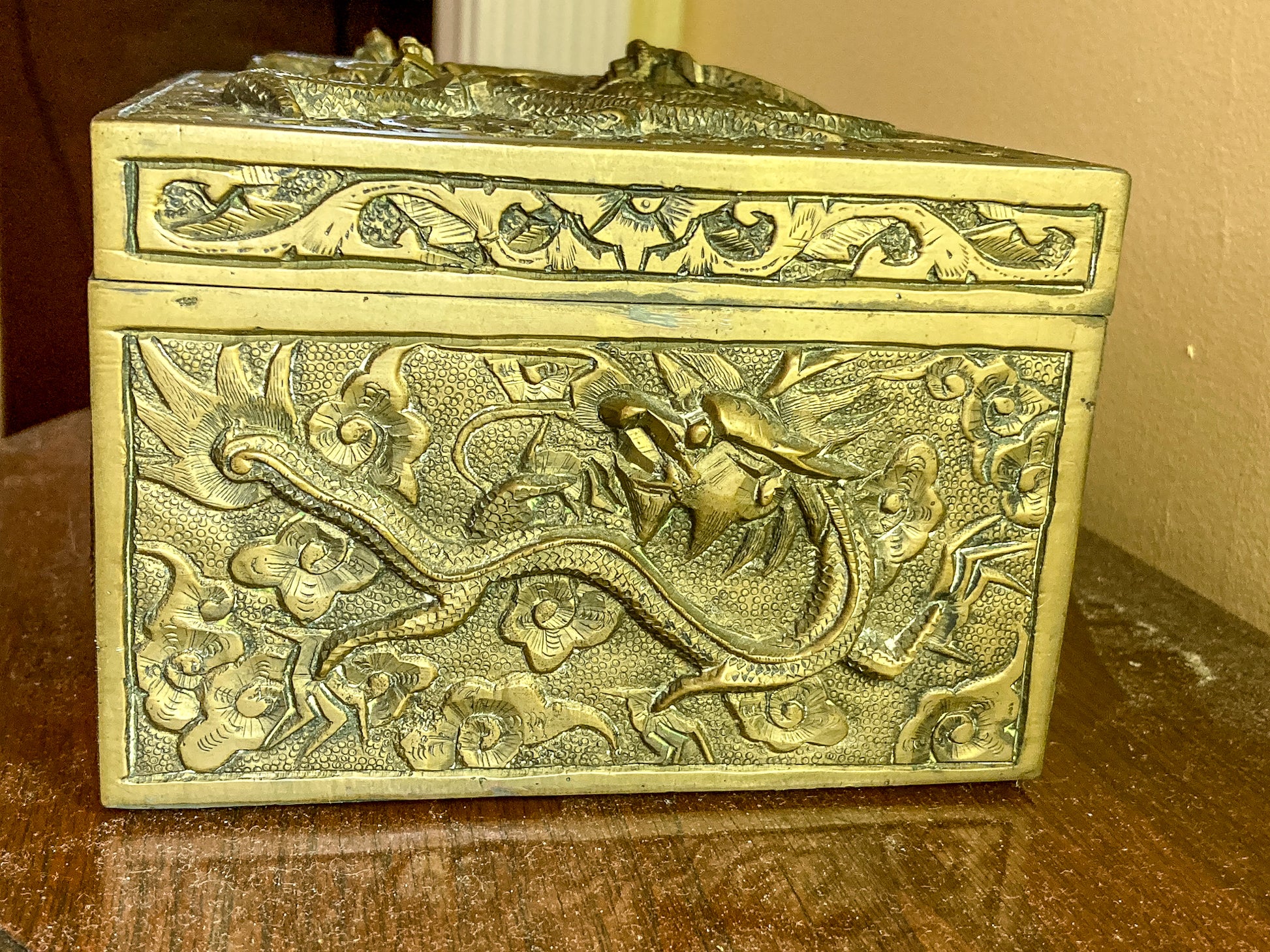 Decorative brass box with intricate designs on a wooden surface Antique Hand Engraved Sculptural Brass Dragon Wood Lined Cigar Box