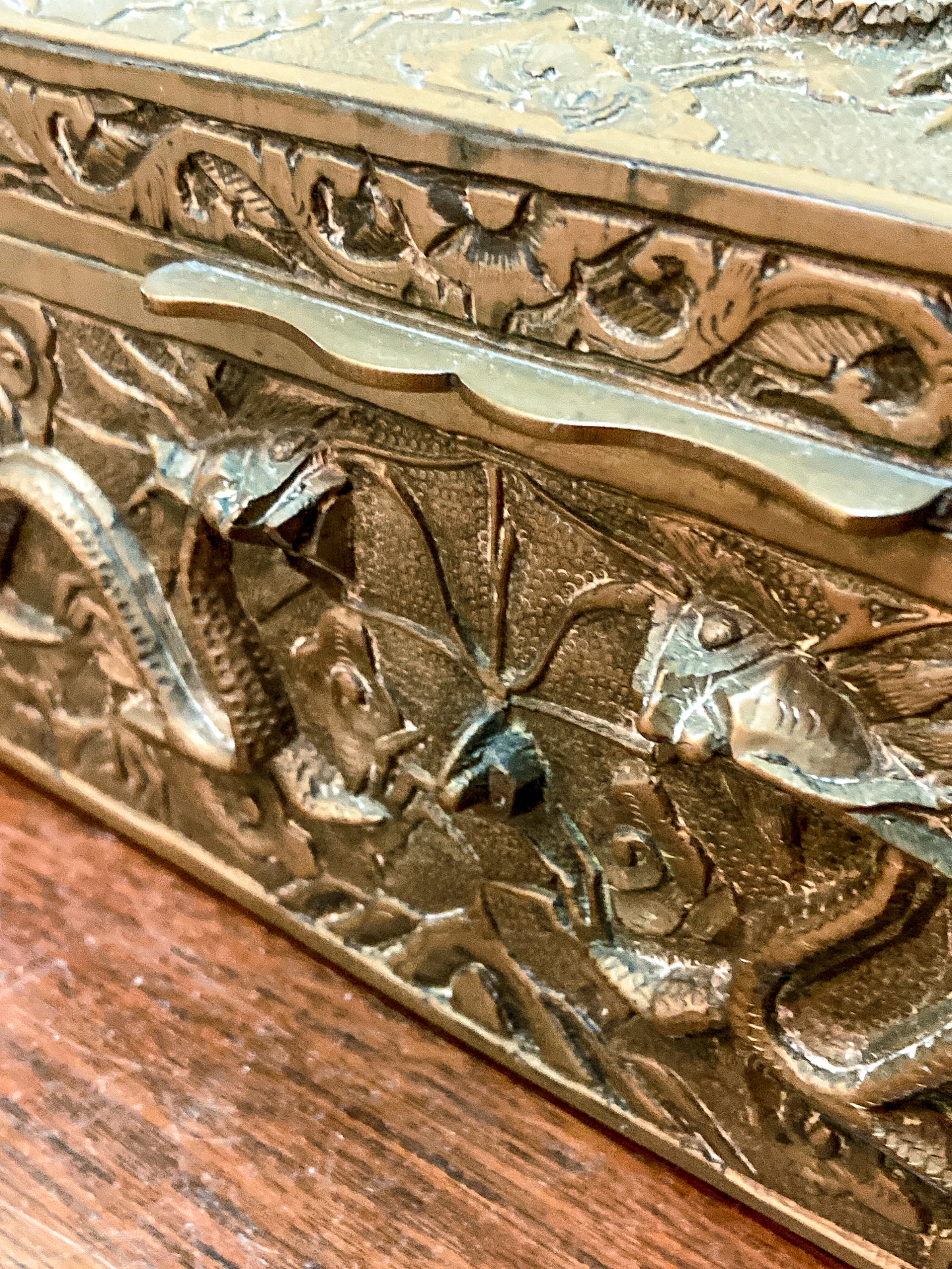 Decorative brass box with intricate engravings on a wooden surface Antique Hand Engraved Sculptural Brass Dragon Wood Lined Cigar Box