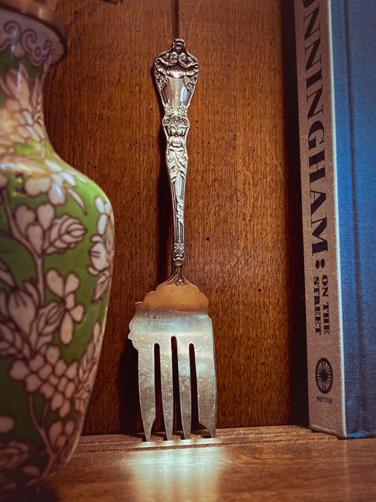 Antique Poppy Flower Pattern Baker Manchester Co Sterling Silver Cold Meat Serving Fork against wooden background