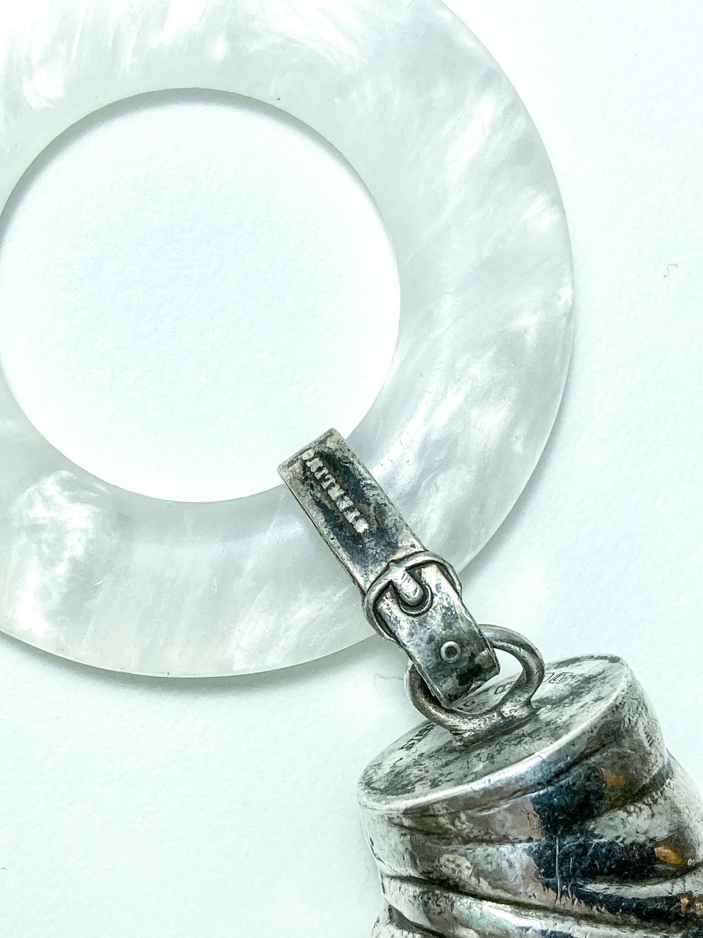 Antique Victorian Sterling Silver Baby Shoe Mother of Pearl Rattle on white background close up