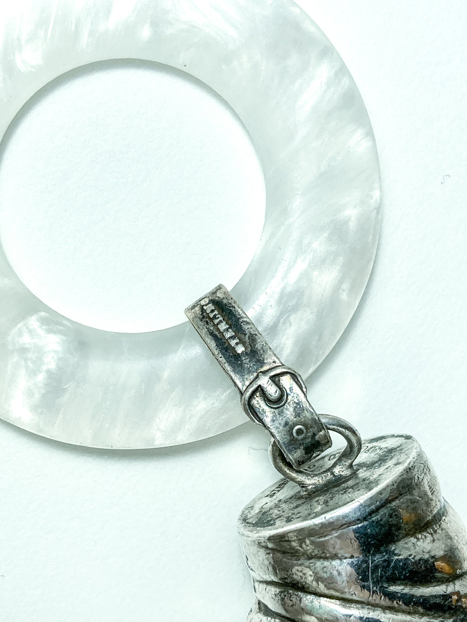 Antique Victorian Sterling Silver Baby Shoe Mother of Pearl Rattle on white background close up