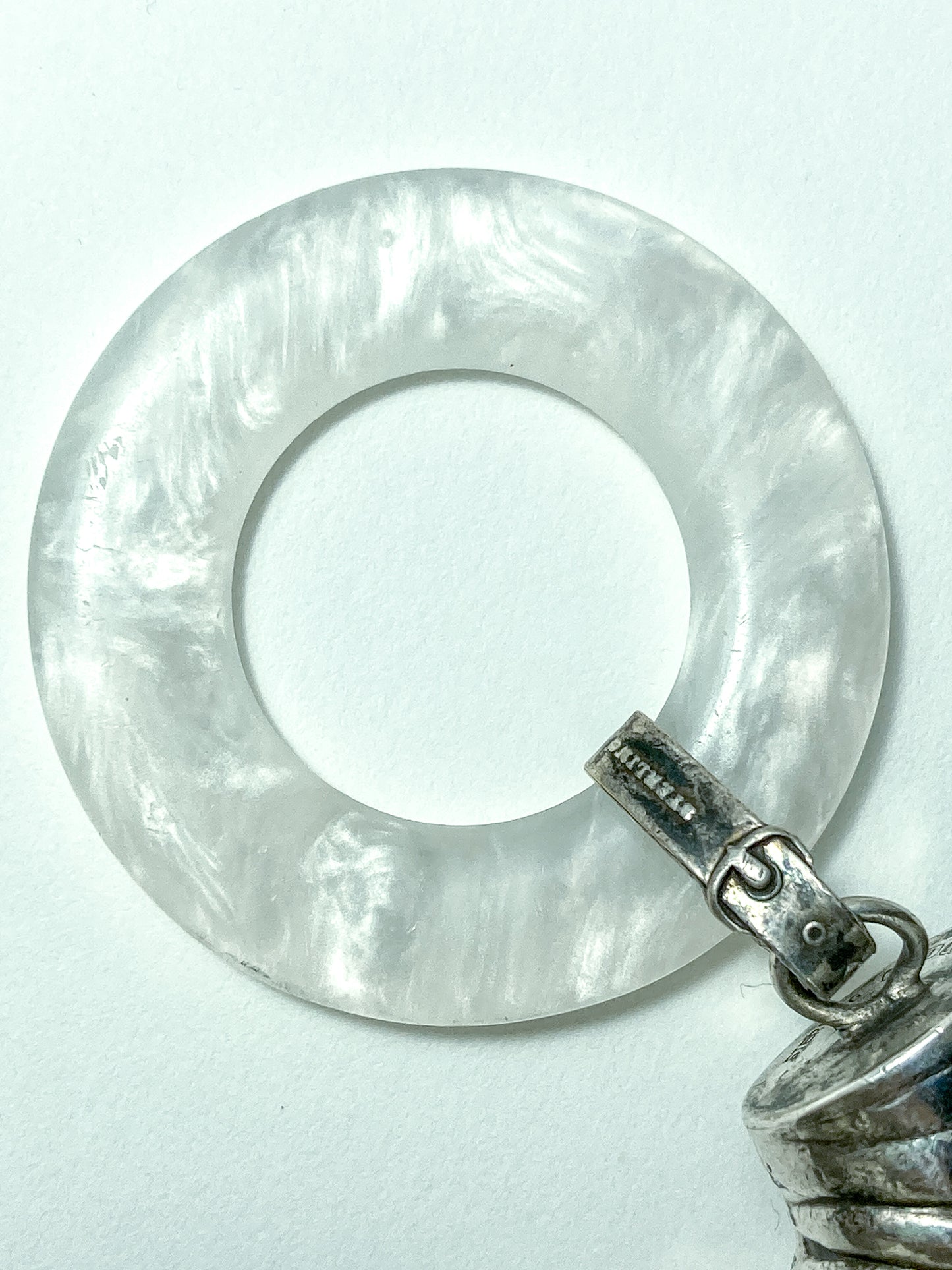 Antique Victorian Sterling Silver Baby Shoe Mother of Pearl Rattle on white background close up