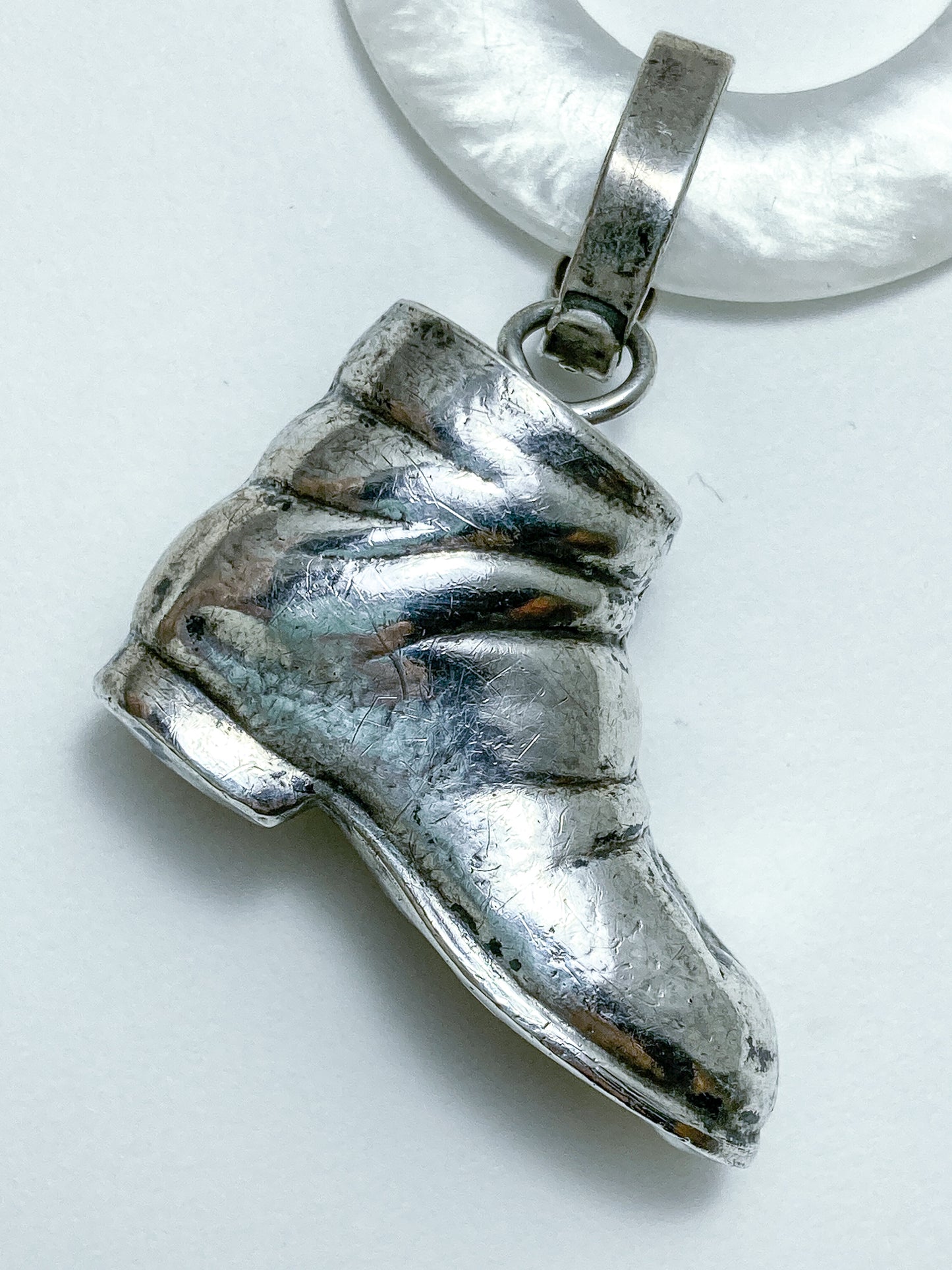 Antique Victorian Sterling Silver Baby Shoe Mother of Pearl Rattle on white background