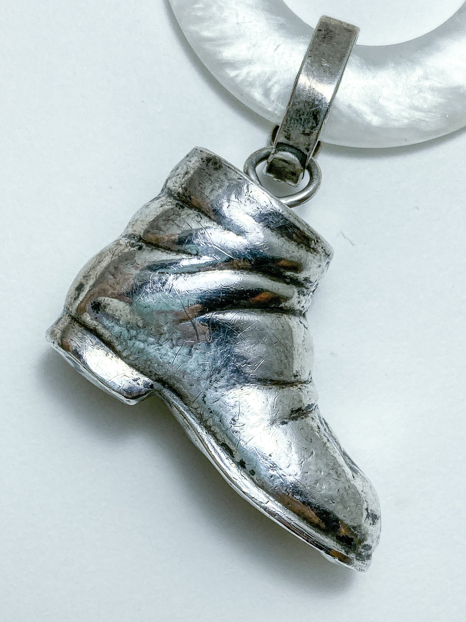 Antique Victorian Sterling Silver Baby Shoe Mother of Pearl Rattle on white background