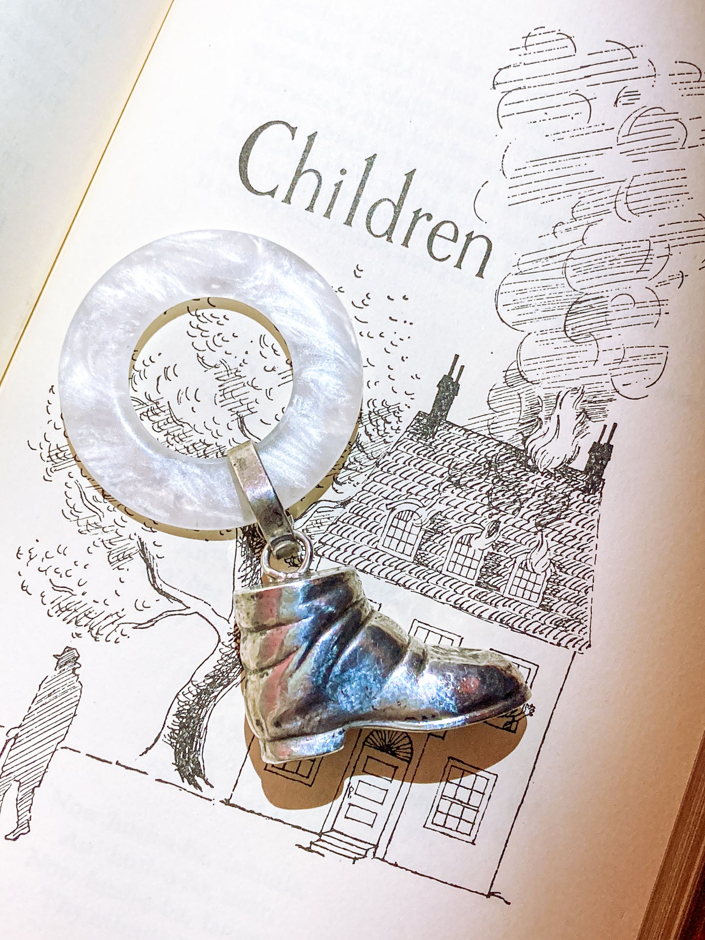 Antique Victorian Sterling Silver Baby Shoe Mother of Pearl Rattle on illustrated page background that says children