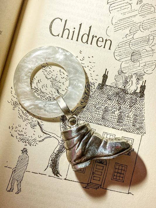 Antique Victorian Sterling Silver Baby Shoe Mother of Pearl Rattle on book page illustration that says Children
