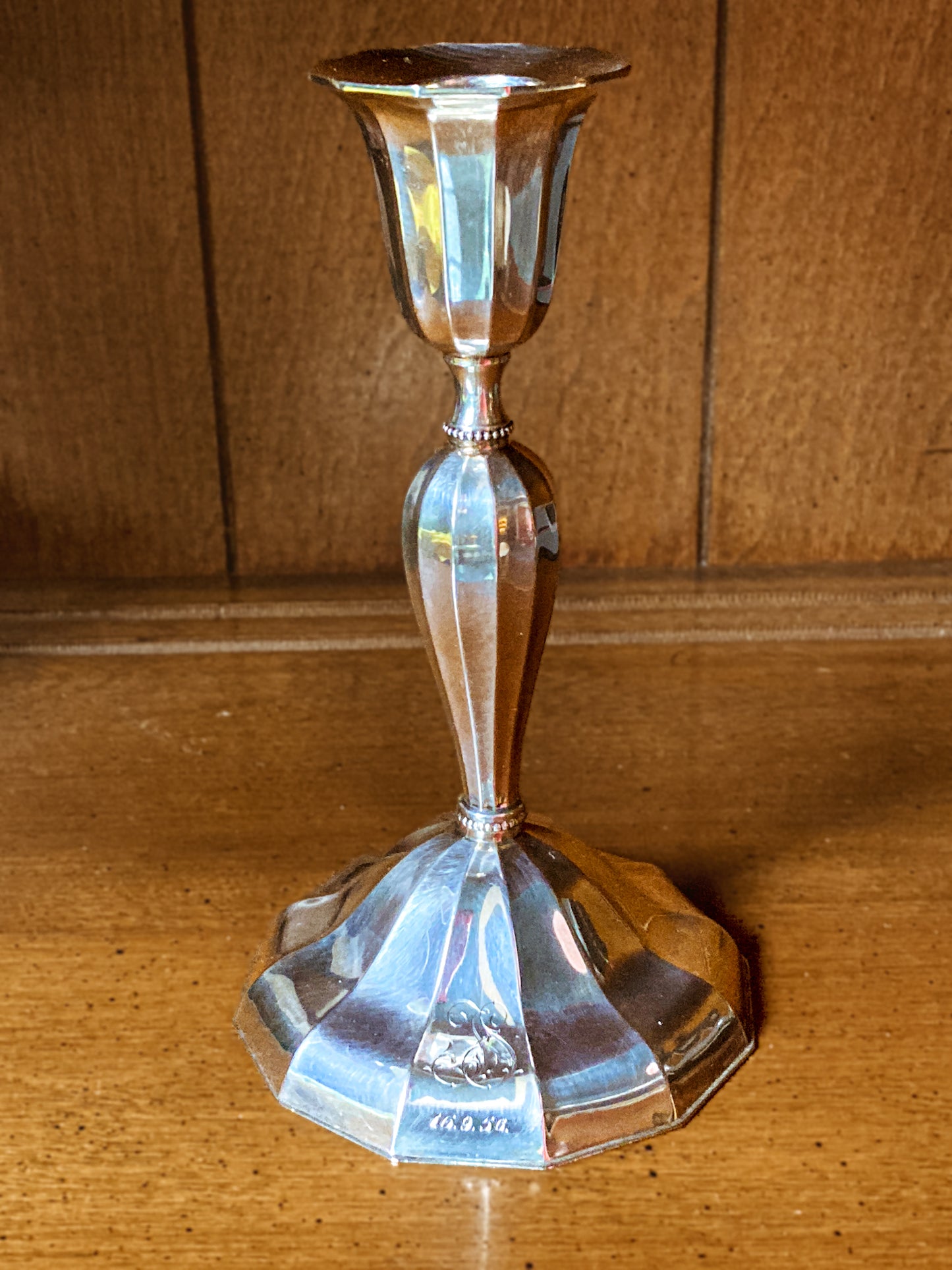 Silver candle holder on a wooden surface Elegant Vintage 1956 Finnish Sterling Silver Monogramed Candlestick