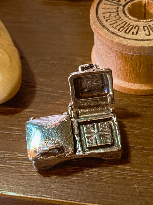 Vintage Sterling Silver Miniature Double Waffle Iron Griddle Charm Jewelry on wood background