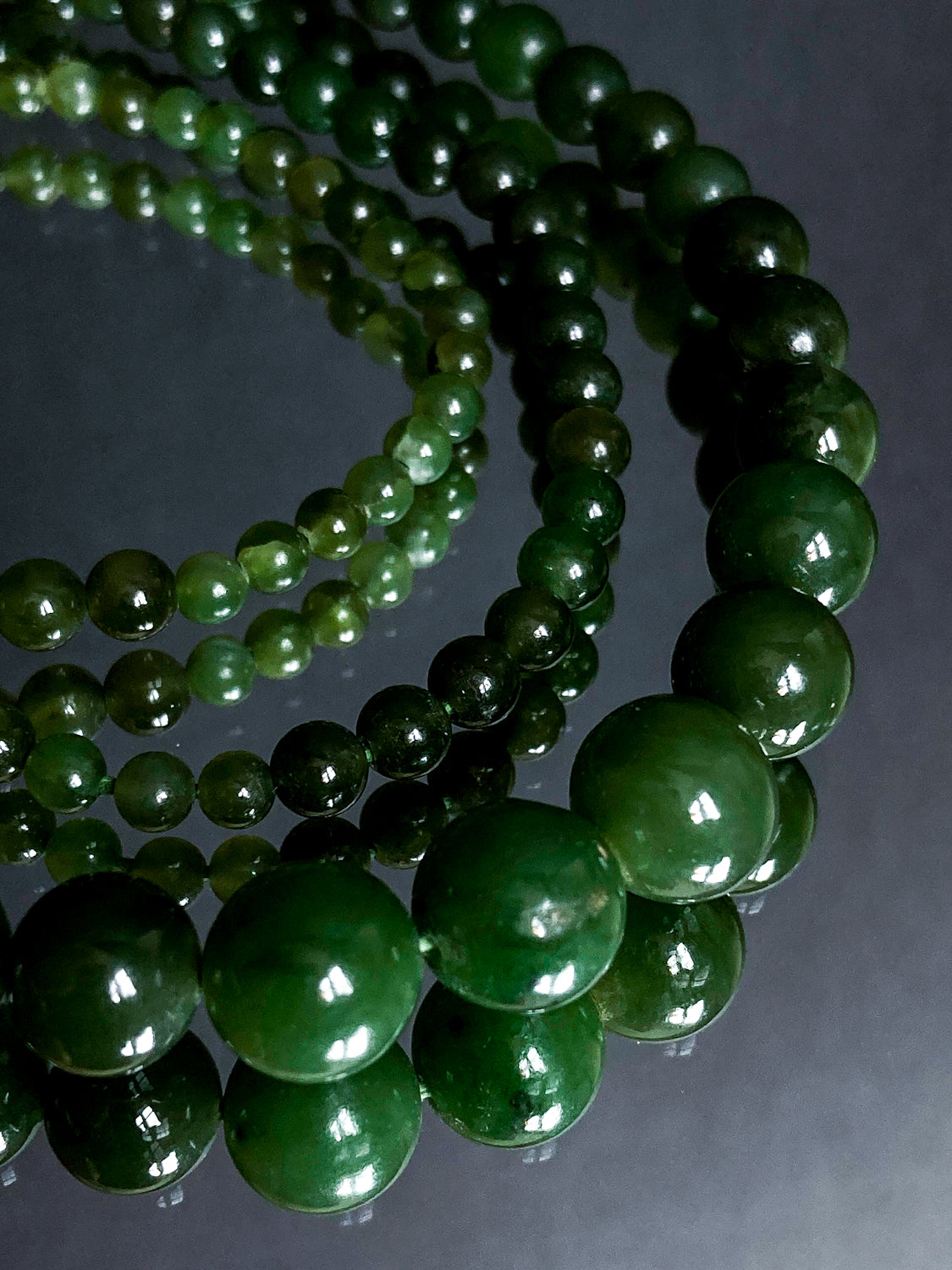 Vintage Graduated Green Nephrite Stone Bead Elongated Necklace Close Up on mirror