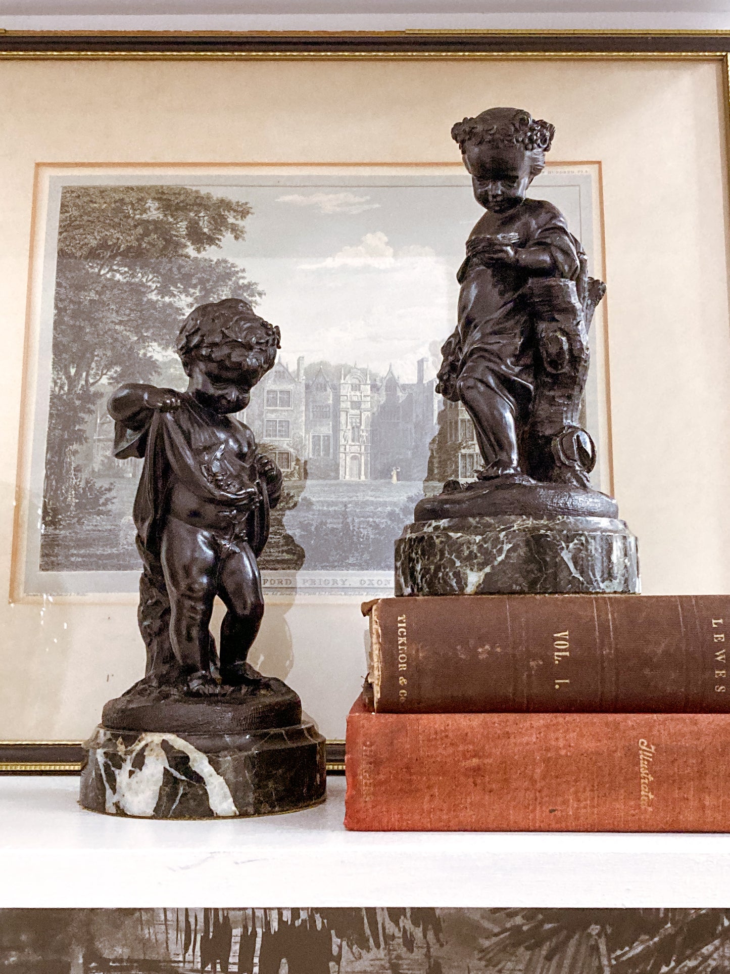 19th Century Pair of Bronze Neoclassical Child Figures on Marble After Etienne Falconnet on books in front of print