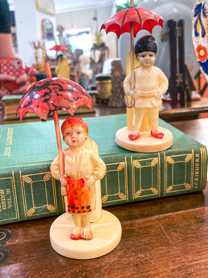 Pair Antique Celluloid Folk Figural Couple with Umbrellas Toothpick Holders