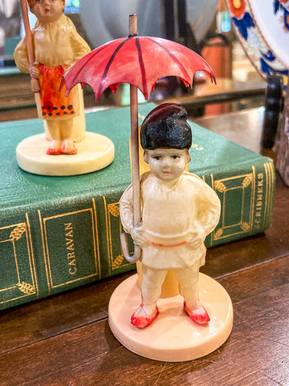 Pair Antique Celluloid Folk Figural Couple with Umbrellas Toothpick Holders