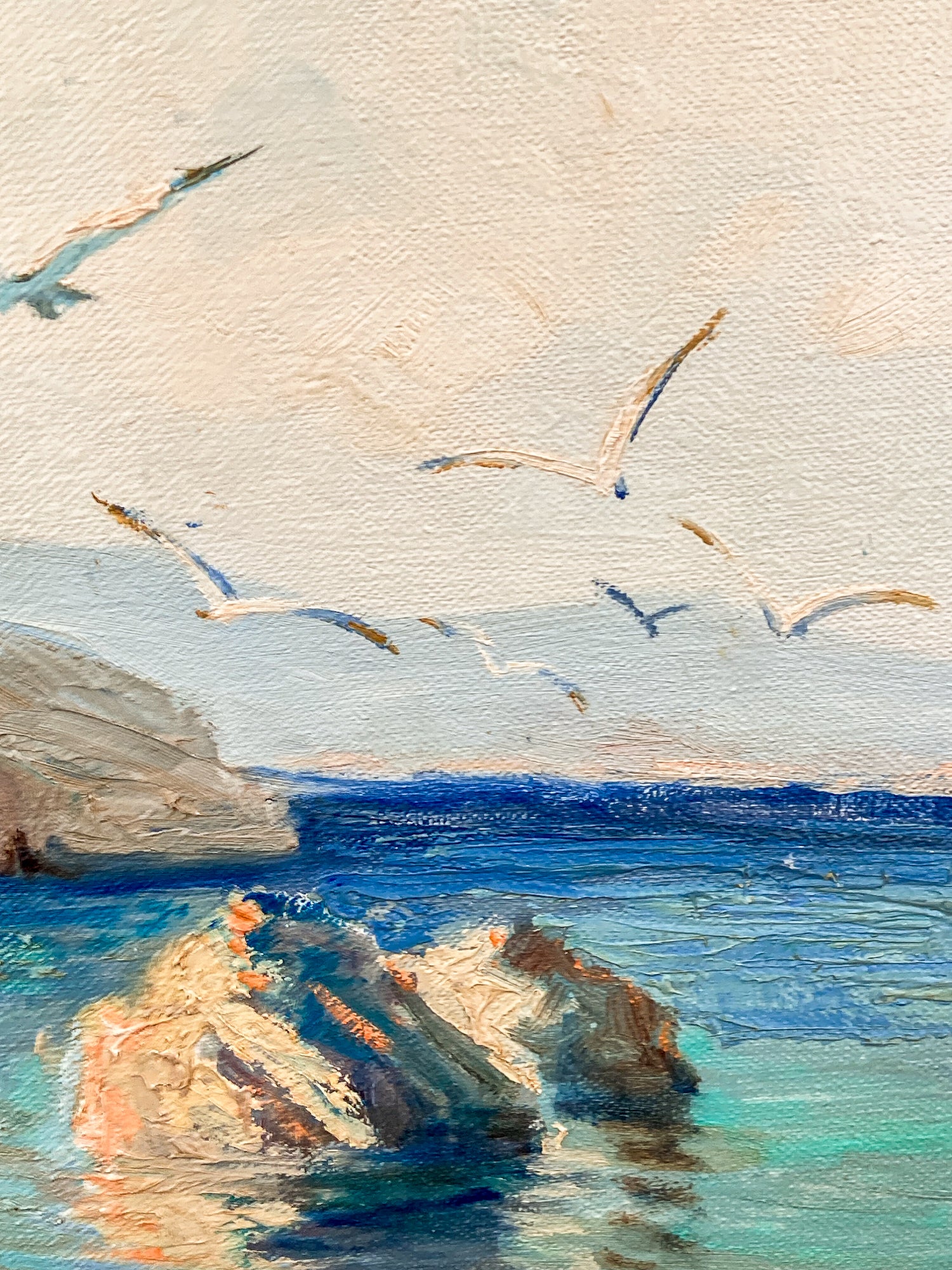 Impressionistic painting of seagulls flying over a blue ocean with rocky shoreline and pale sky. Vintage 1960s Greece Village Seaside Boat Dock Landscape Signed Framed Oil Painting