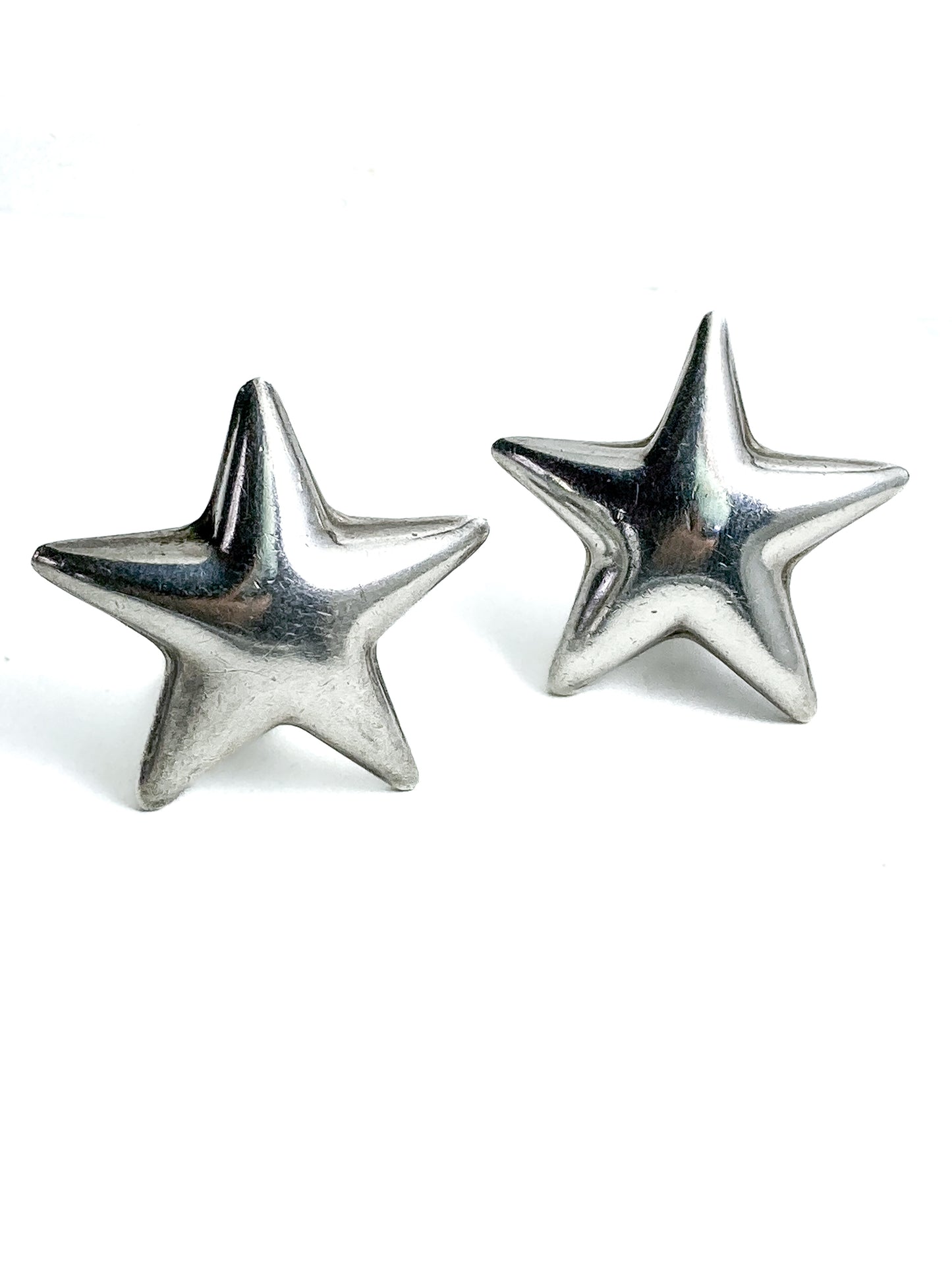 Pair of silver star-shaped earrings on a white background Vintage 925 Sterling Silver Dimensional Bubble Star Clip On Earrings