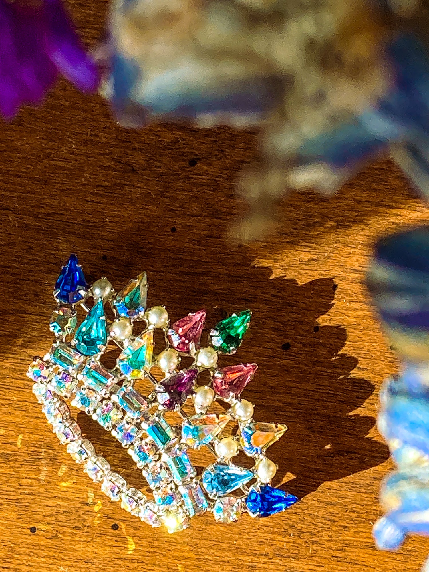 Vintage B. David Colorful Iridescent Rhinestone Pearl Crown Brooch Pin Jewelry on wood  surface