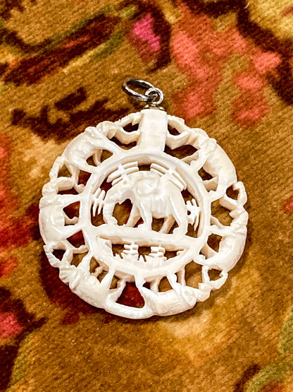 Vintage Carved Celluloid Trunk Holding Elephants Round Pendant