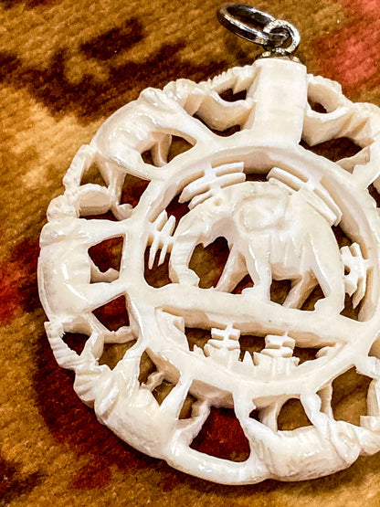 Vintage Carved Celluloid Trunk Holding Elephants Round Pendant