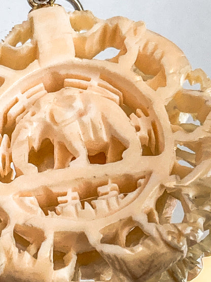 Vintage Carved Celluloid Trunk Holding Elephants Round Pendant
