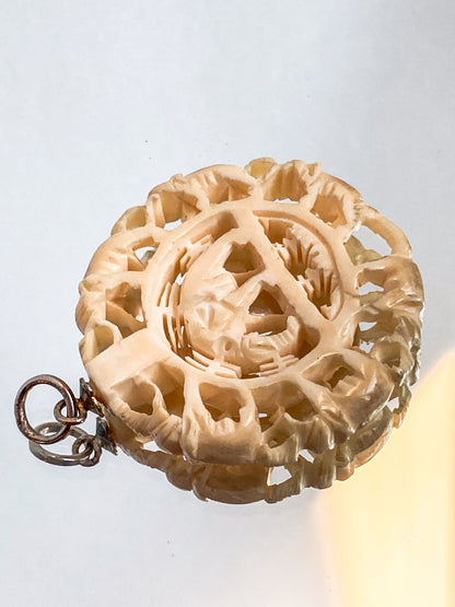 Vintage Carved Celluloid Trunk Holding Elephants Round Pendant