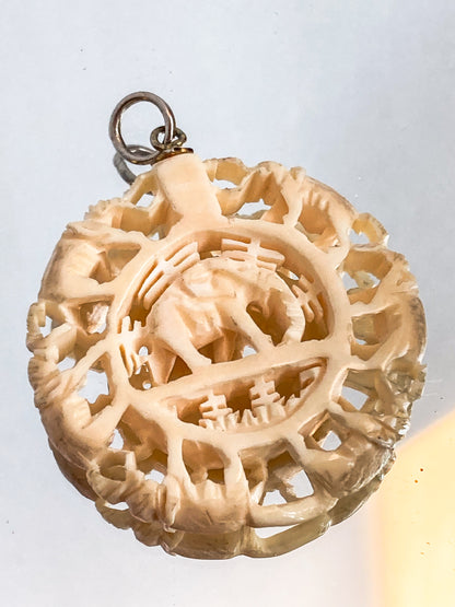 Vintage Carved Celluloid Trunk Holding Elephants Round Pendant