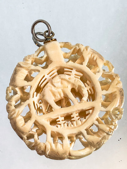Vintage Carved Celluloid Trunk Holding Elephants Round Pendant