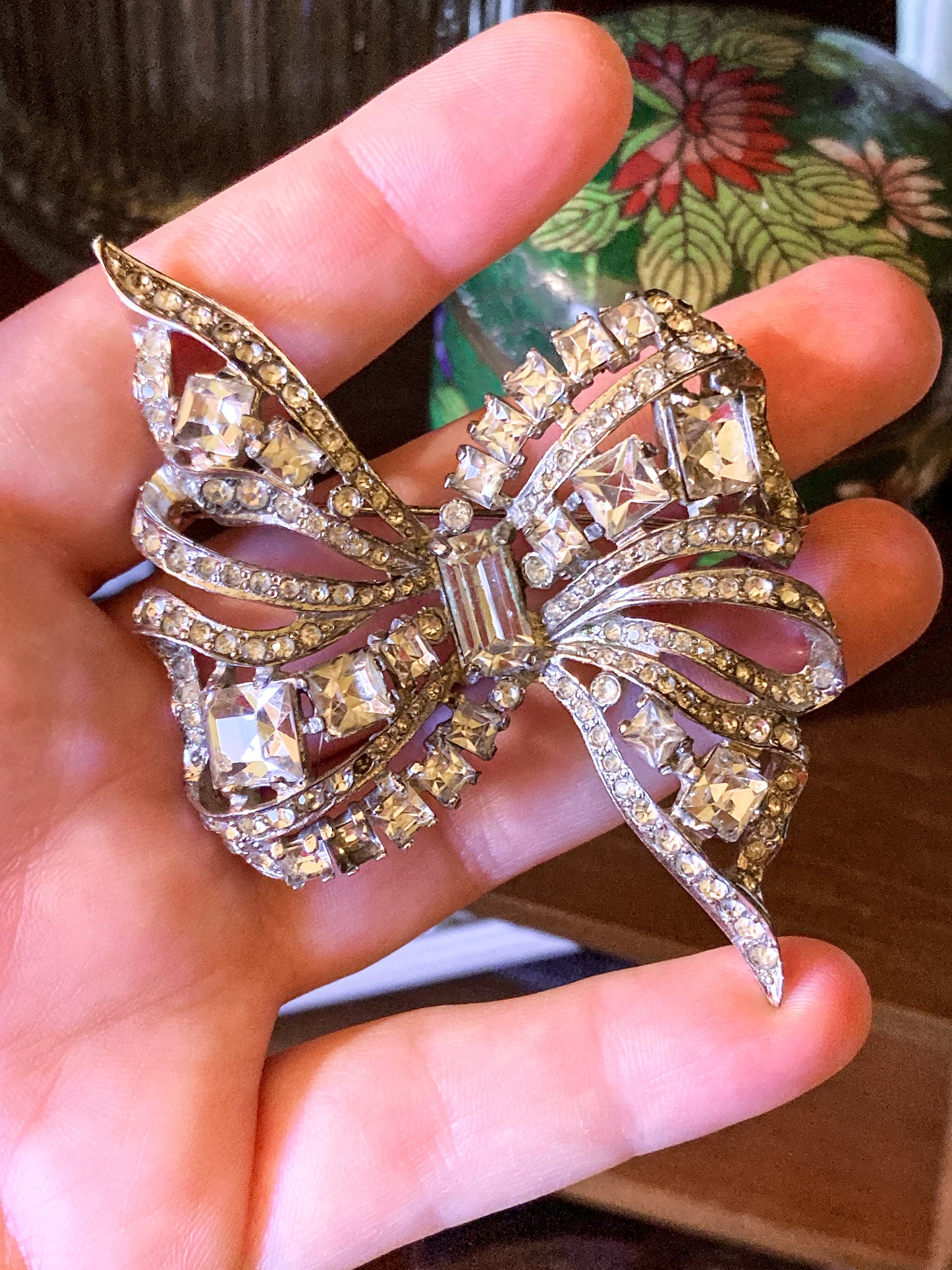 Vintage Coro Sterling Silver Clear Glass Rhinestone Asymmetric Bow Brooch Pin in hand