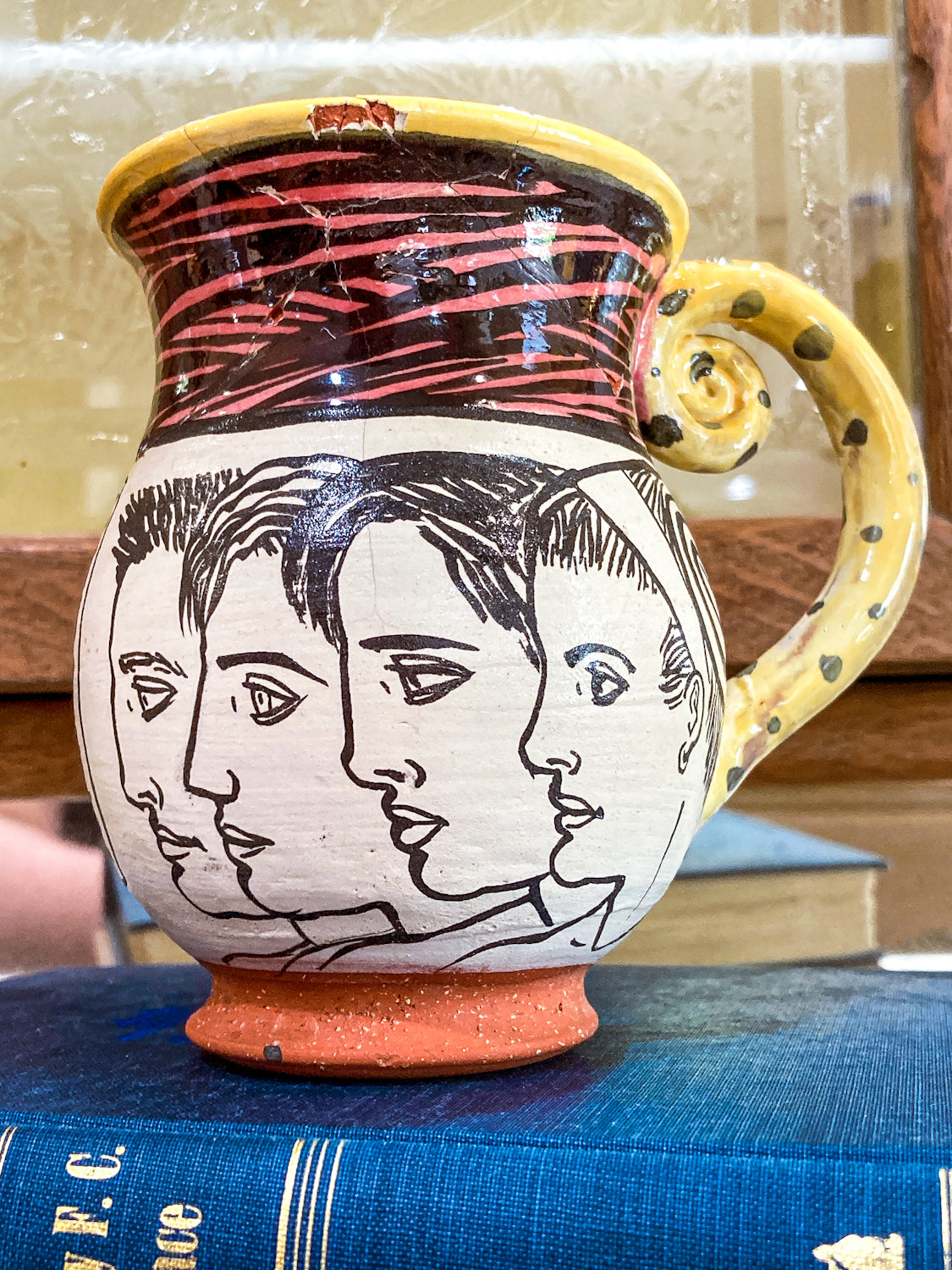 Ceramic mug with artistic face design on a blue surface Vintage Daniel Postotnik Hand Potted Illustrative Portrait Mug As Found