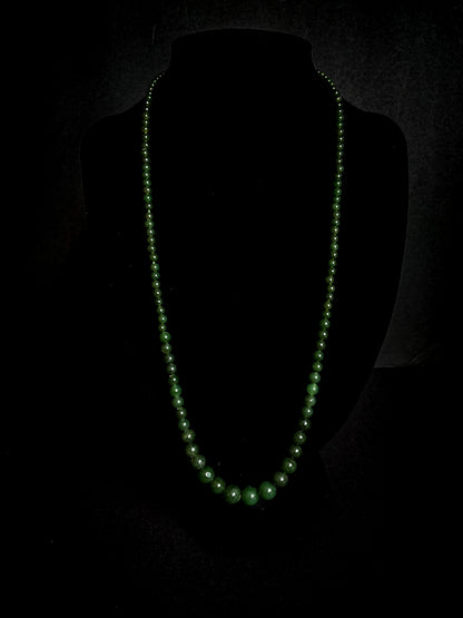 Vintage Graduated Green Nephrite Stone Bead Elongated Necklace on black velvet form