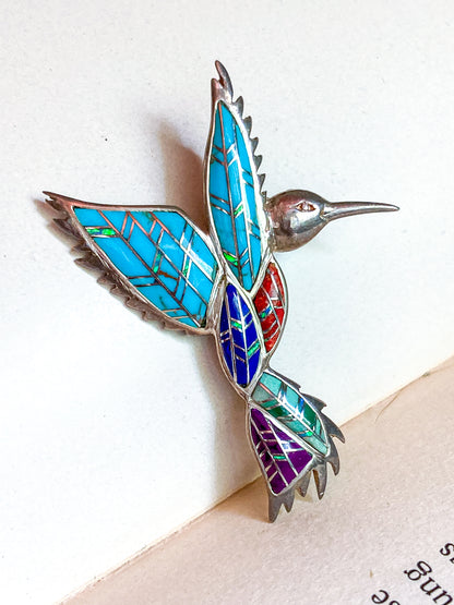 Colorful hummingbird-shaped brooch on a white background Vintage Sterling Silver Turquoise Gemstone Mosaic Inlay Hummingbird Brooch