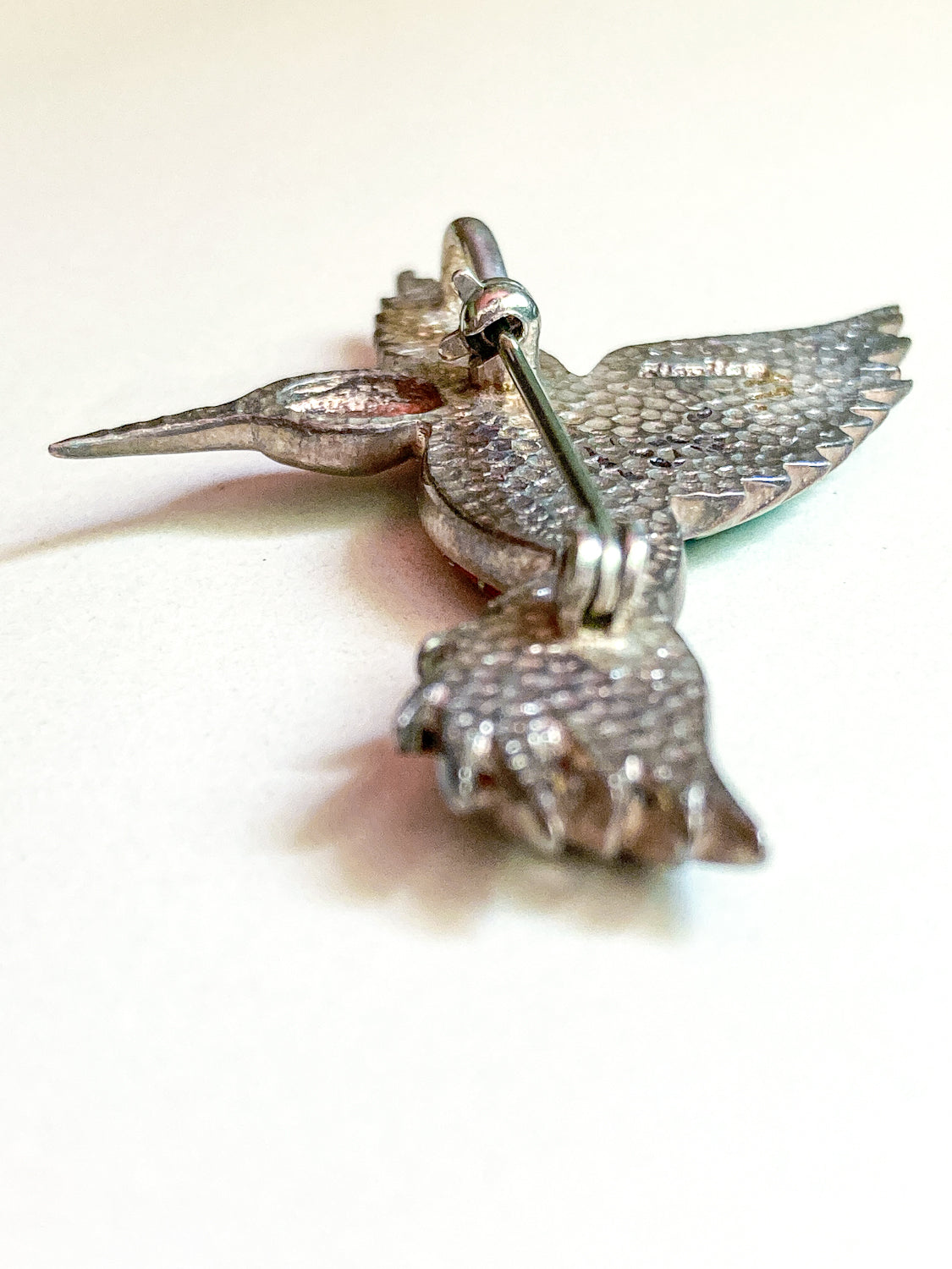 Silver hummingbird brooch on a white background Vintage Sterling Silver Turquoise Gemstone Mosaic Inlay Hummingbird Brooch