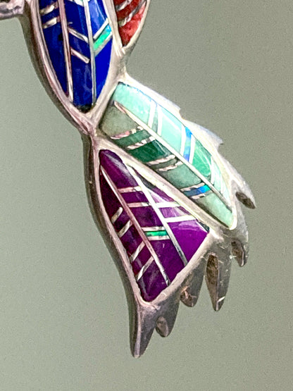 Multicolored inlaid Vintage Sterling Silver Turquoise Gemstone Mosaic Inlay Hummingbird Brooch on a gray background
