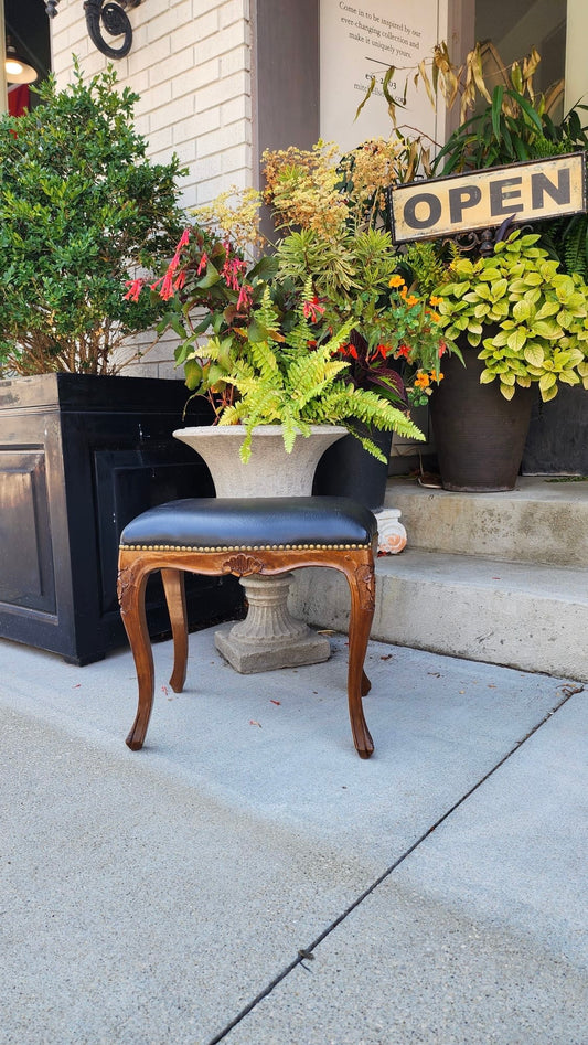 A Vintage Leather Foot Stool with Nail Head Trim and Carved Wooden Legs