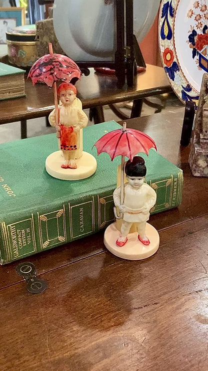 Pair Antique Celluloid Folk Figural Couple with Umbrellas Toothpick Holders