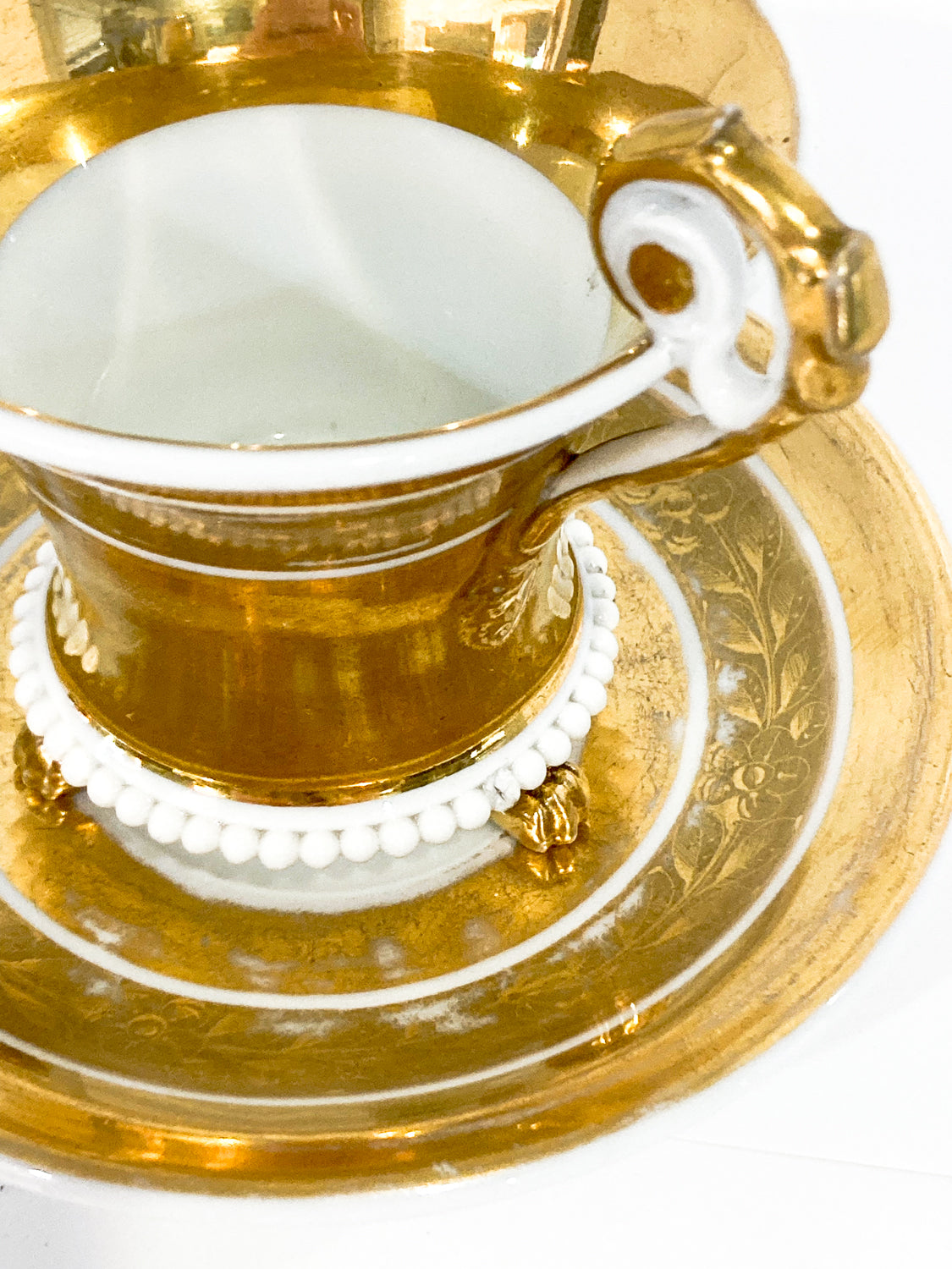 Antique Regal Golden Claw Foot Gilded Porcelain Cup & Saucer Set Slightly Above angle